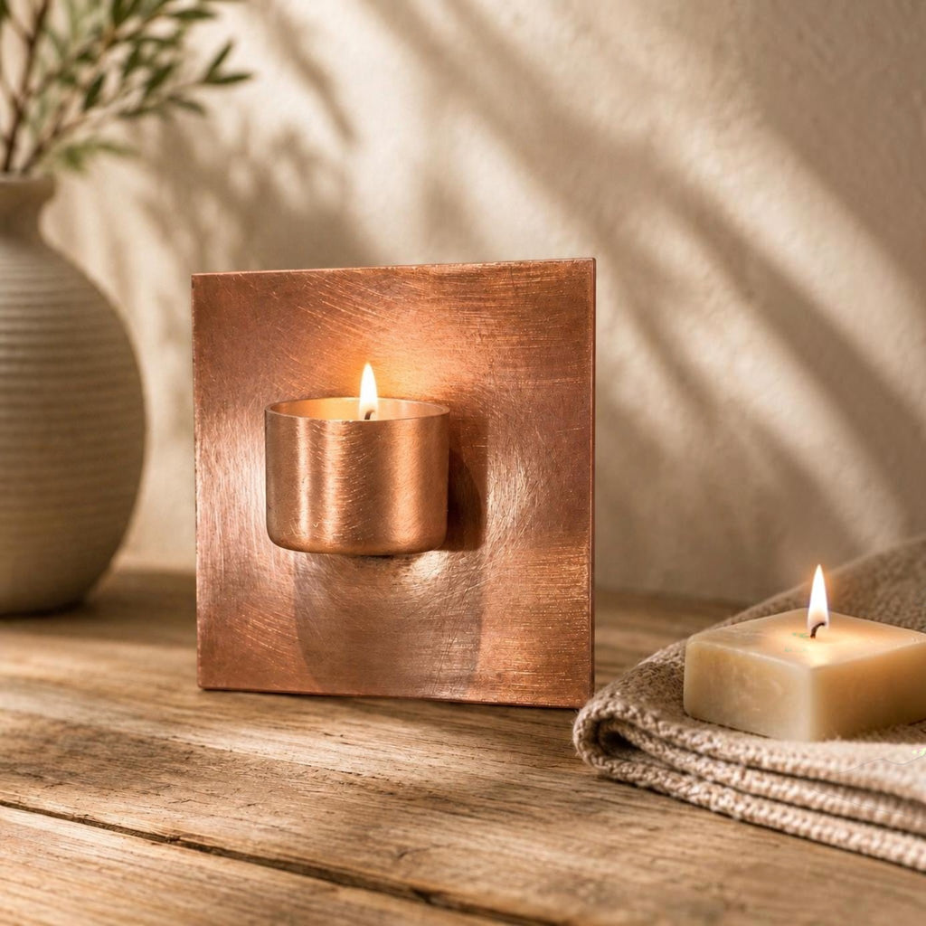 Handcrafted copper tea light holder for a garden wall