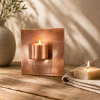 Handcrafted copper tea light holder for a garden wall