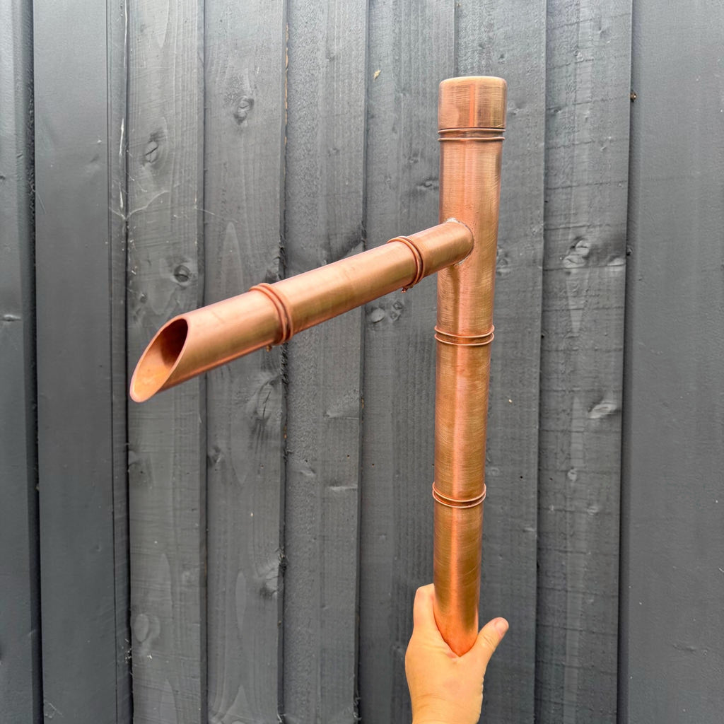Japanese-inspired copper water spout for a garden pond