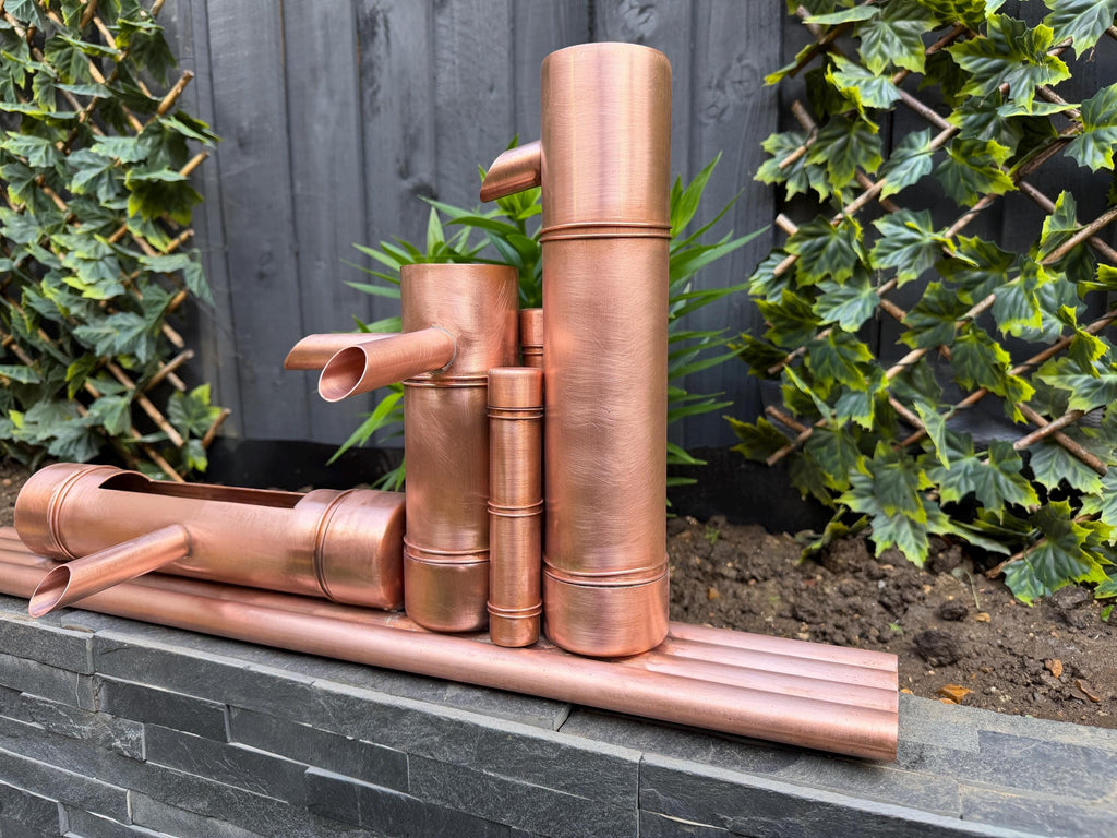 Copper Zen-style garden water feature with bamboo-inspired form