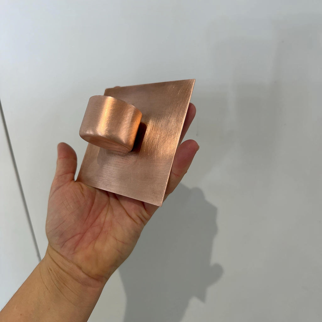 Copper wall-mounted candle holder for a patio or garden