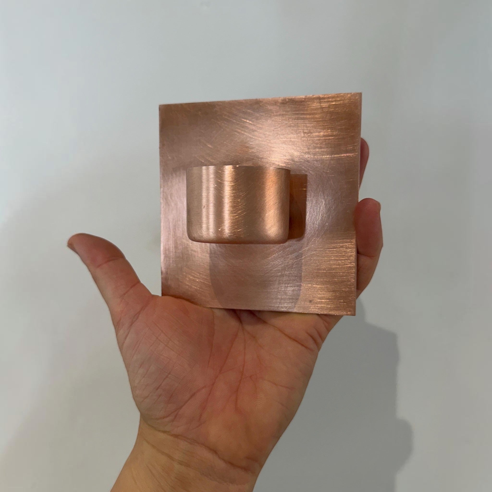 Copper tea light holder with wall-mounted design