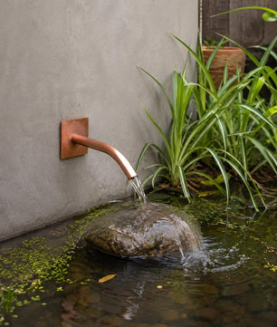 22mm Curved Copper Water Spout - 250mm - installed garden feature
