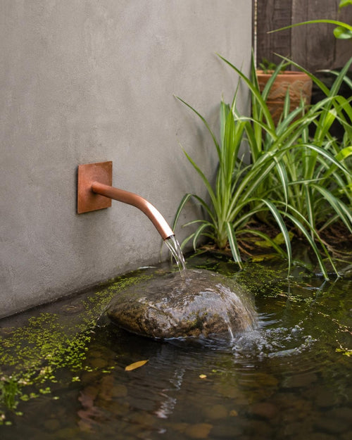 22mm Curved Copper Water Spout - 250mm - installed garden feature