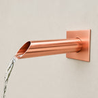 Spoutcraft Studio custom copper water spout, 35mm diameter, with angled outlet, for garden fountains and water walls.